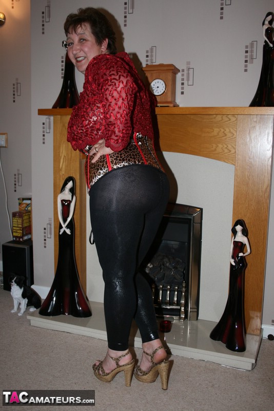 Chubby granny takes off her red blouse and displays her big body before she takes off her multi colored leopard print corset and expose her large breasts in different poses wearing her black leggings and brown and black high heels on the floor. - XXXonXXX - Pic 3