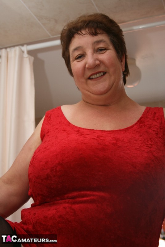 Alluring granny peels off her red dress and seduces with her plus size body in red and black lingerie, black stockings and red high heels in different poses in the bathroom. - XXXonXXX - Pic 8