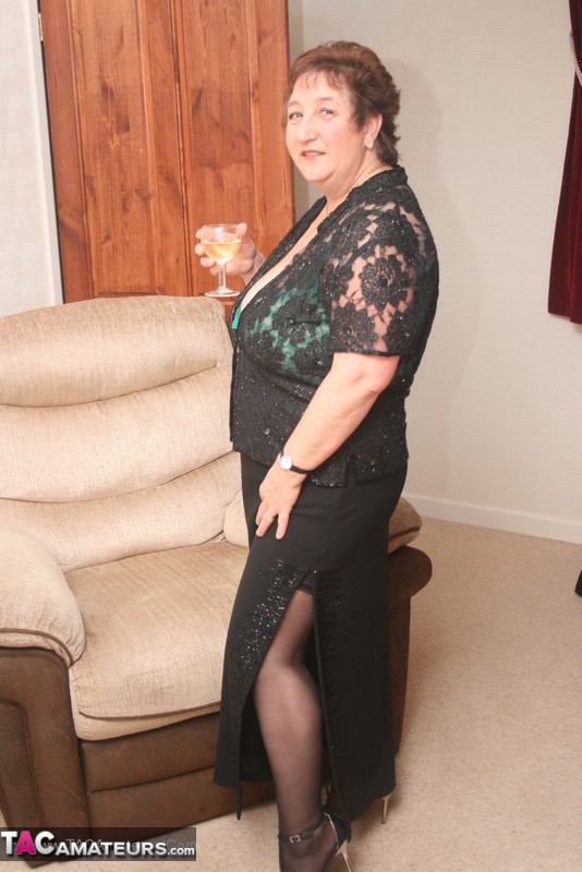 Steaming hot granny peels off her black blouse and skirt then pose her plus size body in green lingerie, black stockings and high heels. - XXXonXXX - Pic 6