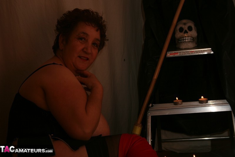 Luscious granny with plus size body expose her large breasts in black lingerie, stockings and red boots before she pulls her panty aside and reveals her nasty crack as she spreads wide on the floor. - XXXonXXX - Pic 11