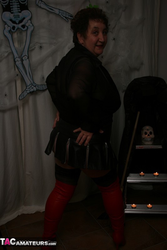 Hot granny takes off her black jacket and teases with her monster tits and chubby body in red and black lingerie, black skirt, stockings and red boots. - XXXonXXX - Pic 7