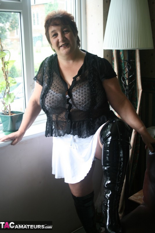 Hot granny peels off her black blouse and teases with her plus size body then shows her gigantic breasts wearing her white lingerie, skirt and black boots in different poses. - XXXonXXX - Pic 6