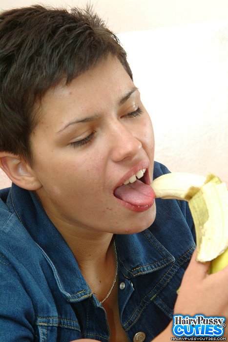 Red nailed brunette with short hair and pierced belly eating banana before undressing on the table and fingering her hairy holes - XXXonXXX - Pic 2