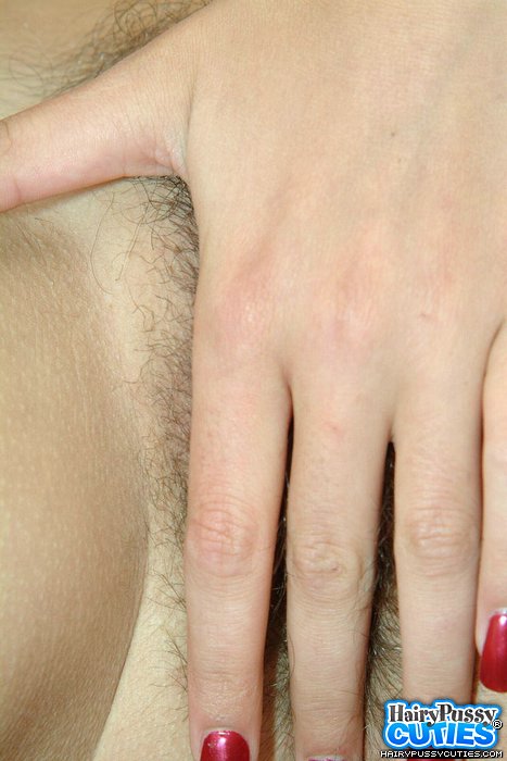 Busty brunette with red nails and pierced belly sheds white outfit to expose big breast and hairy vagina on the chair - XXXonXXX - Pic 10