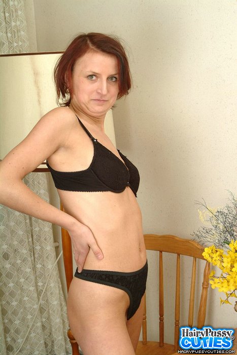 Older redhead in green outfit and black undies slowly getting nude and fingering her bushy coochie on the chair - XXXonXXX - Pic 8