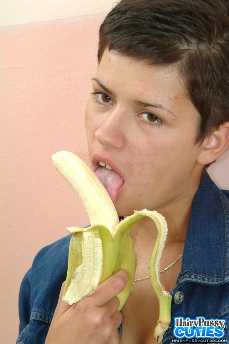 Short haired brunette in jeans outfit and black panty eating banana and fingering her hairy twat before posing naked on the table - XXXonXXX - Pic 2