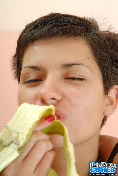 Short haired brunette in jeans outfit and black panty eating banana and fingering her hairy twat before posing naked on the table - XXXonXXX - Pic 10