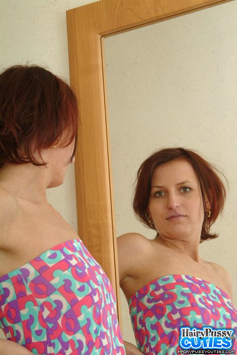 Small breasted redhead in white undies and colorful outfit stripteasing by the mirror and showing her hairy snatch - XXXonXXX - Pic 1
