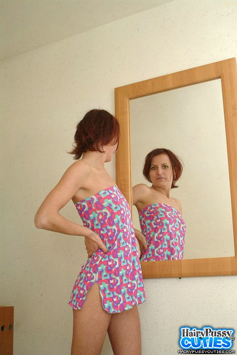 Redhead milf in tight colorful outfit and white panty stripteasing by the mirror to show her small breast and hairy cunt - XXXonXXX - Pic 1