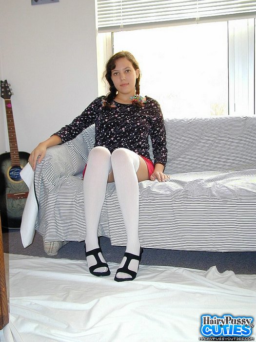 Pigtailed brunette in pink skirt and white hose teasing on the couch and showing her bushy coochie and yummy tits - XXXonXXX - Pic 2