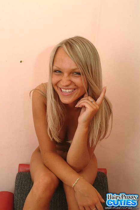 Blonde in pink lingerie and black heels stripteasing on the red chair and fingering her hairy pussy - XXXonXXX - Pic 5