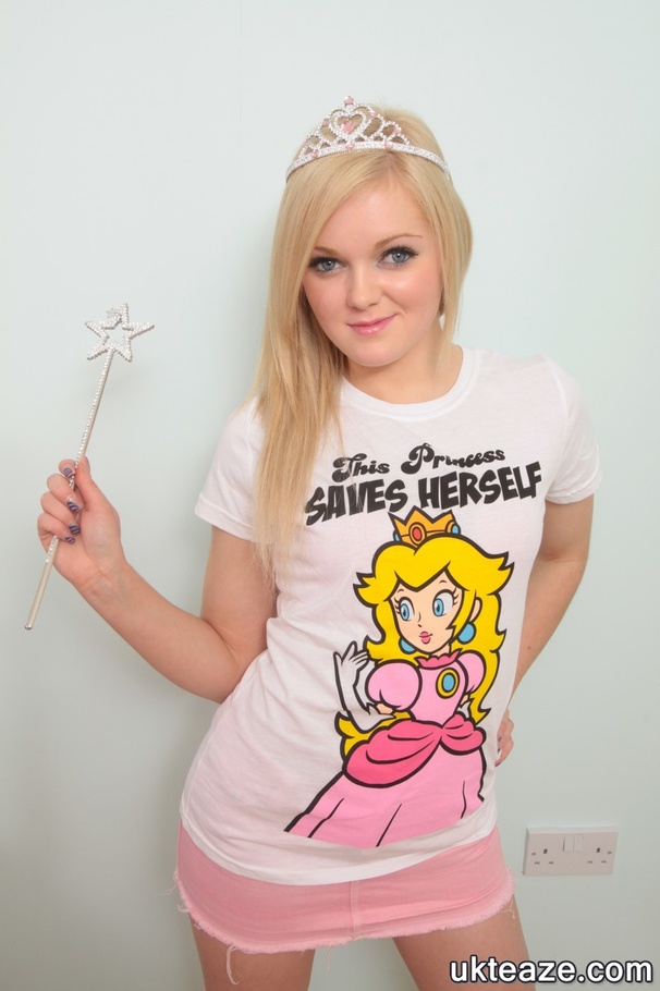 Blonde chick takes off her white fairy shirt and pose her banging body in pink underwear before she peels off her bra and expose her sweet boobs then strips down her panty and bares her lusty pussy in different poses on a rainbow colored bed wearing her pink and white striped socks. - XXXonXXX - Pic 1