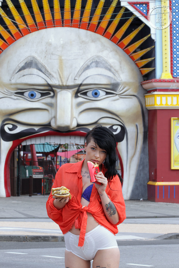 Foxy chick displays her smoking hot body while she eats her burger and fries as she walks around the street wearing her orange shirt, puple bra, white shorts and black high heels. - XXXonXXX - Pic 2