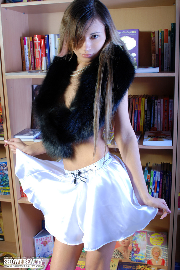 Alluring hottie with a black fur scarf teases with her small tits and banging body then reveals her indulging pussy in different poses in a library wearing her white skirt and black high heels. - XXXonXXX - Pic 3