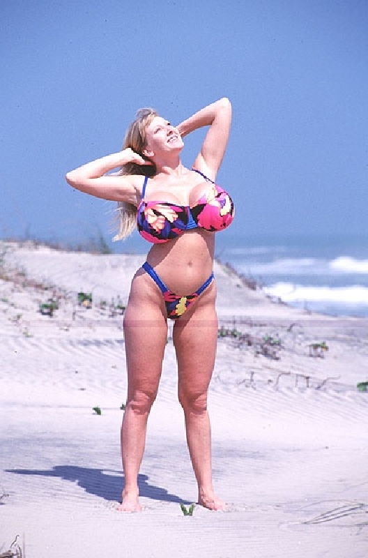 Busty babe in bikini gets naked on the beach and pisses standing. - XXXonXXX - Pic 1