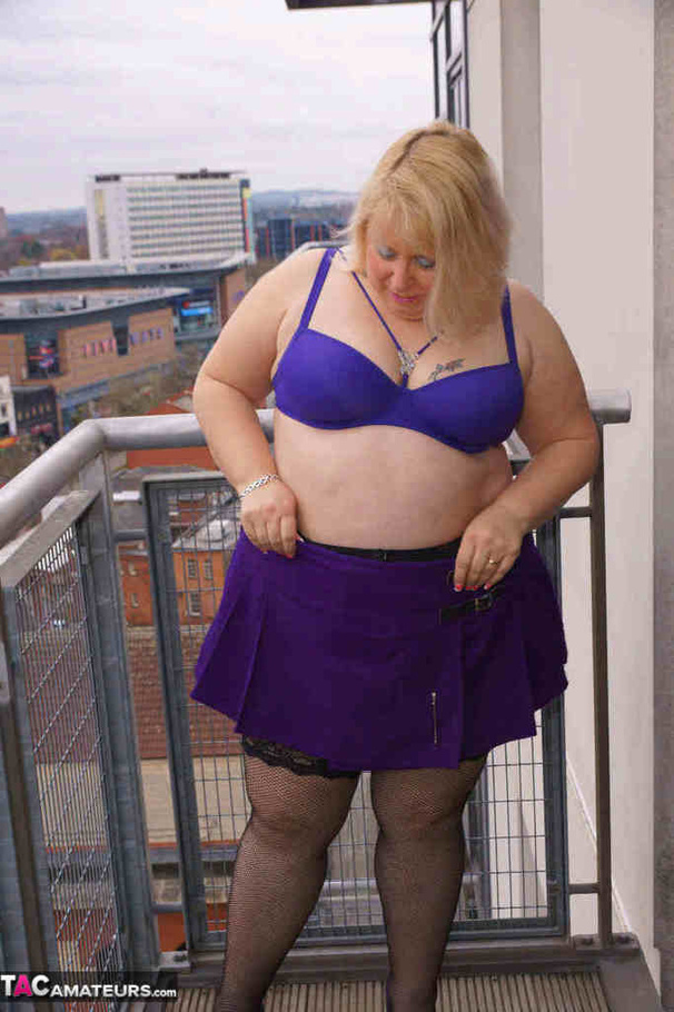 High heeled bbw in black stockings and purple miniskirt sheds blue bra and exposing her pierced snatch on the balcony - XXXonXXX - Pic 8