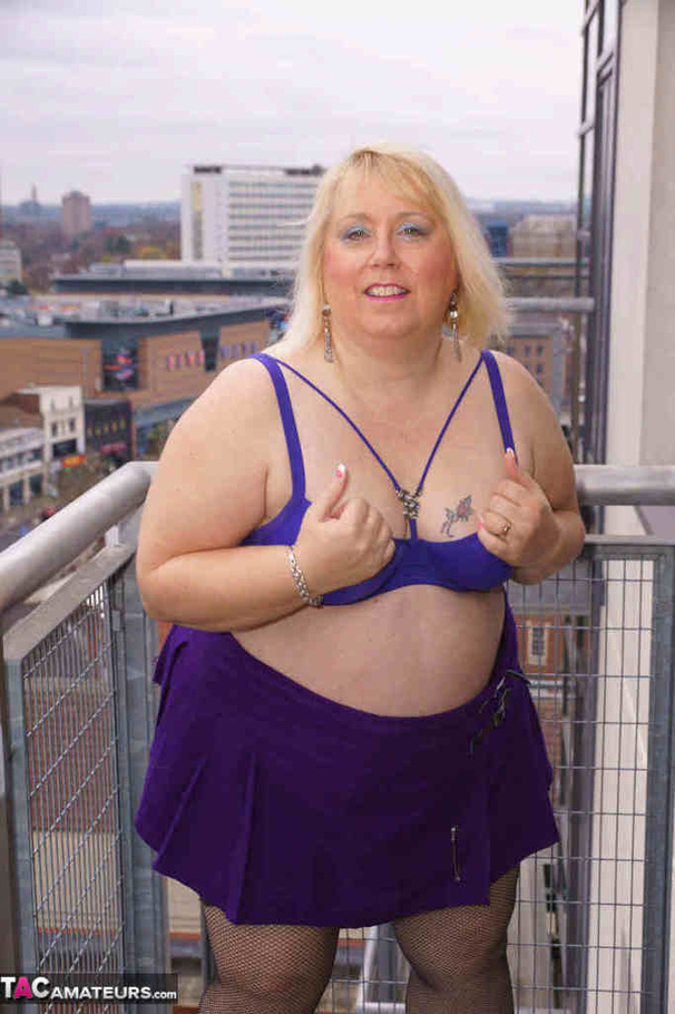 High heeled bbw in black stockings and purple miniskirt sheds blue bra and exposing her pierced snatch on the balcony - XXXonXXX - Pic 9
