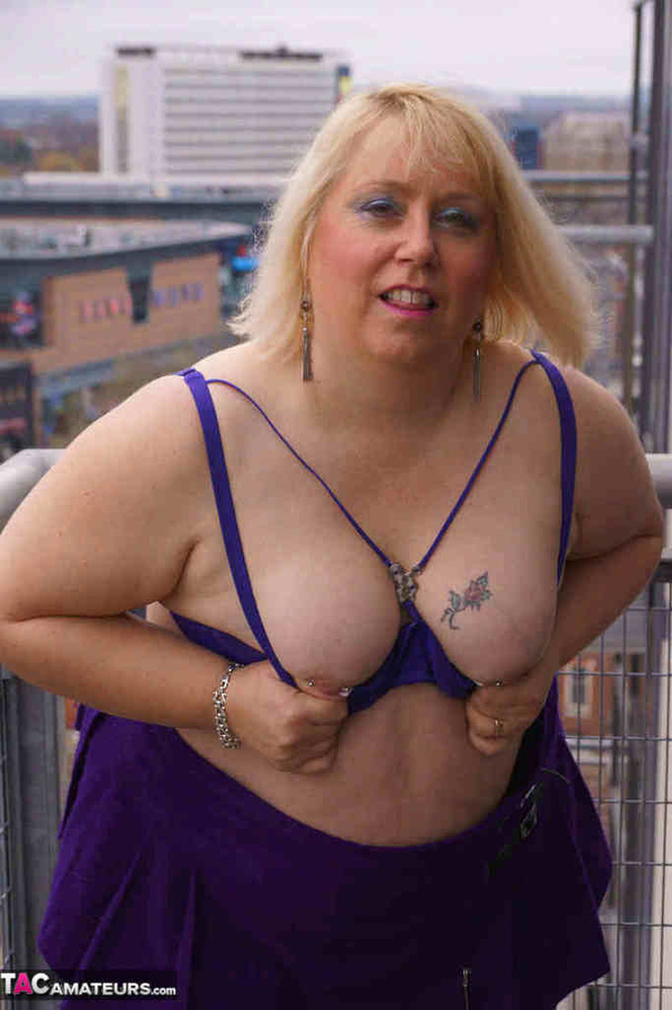High heeled bbw in black stockings and purple miniskirt sheds blue bra and exposing her pierced snatch on the balcony - XXXonXXX - Pic 10