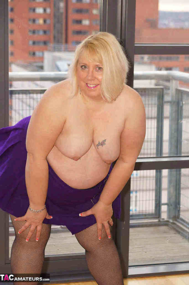 High heeled bbw in black stockings and purple miniskirt sheds blue bra and exposing her pierced snatch on the balcony - XXXonXXX - Pic 20