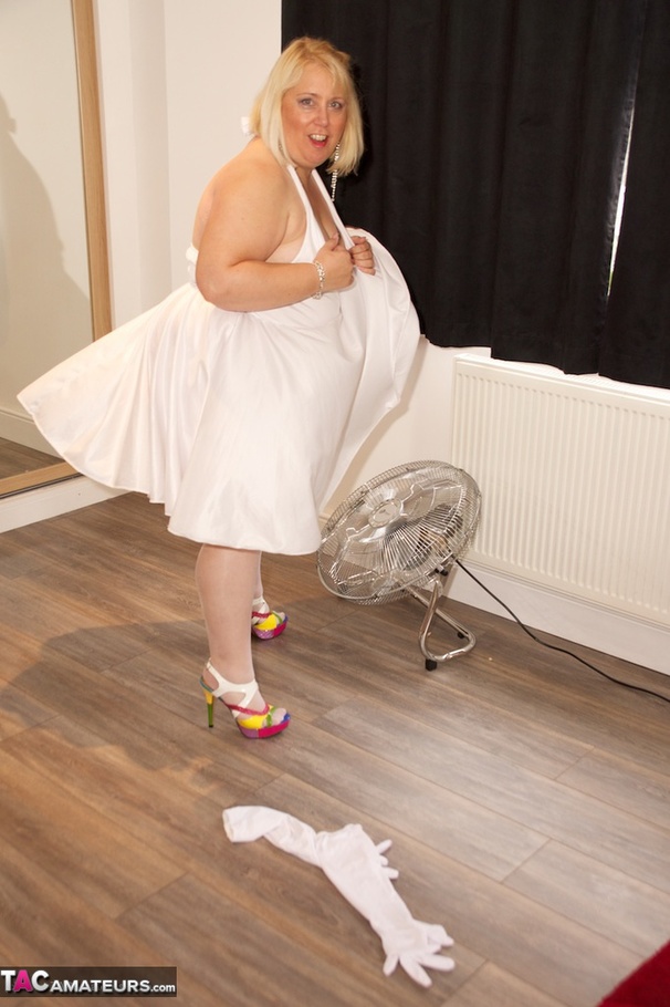 Big sized blonde in white dress and stockings teasing by the fan and showing her small breast - XXXonXXX - Pic 9