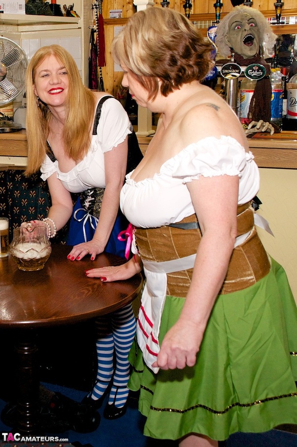 A pair of chubby ladies in national bavarian outfit teasing on a cam and let two guys lick their shaved twats - XXXonXXX - Pic 4