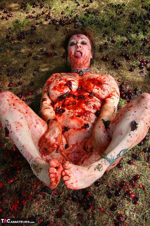 Chubby brunette with big tits gets her tattooed body covered with plums while posing on the ground outdoors - XXXonXXX - Pic 10