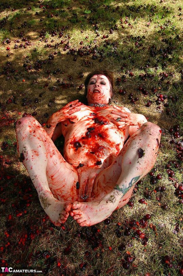 Chubby brunette with big tits gets her tattooed body covered with plums while posing on the ground outdoors - XXXonXXX - Pic 11