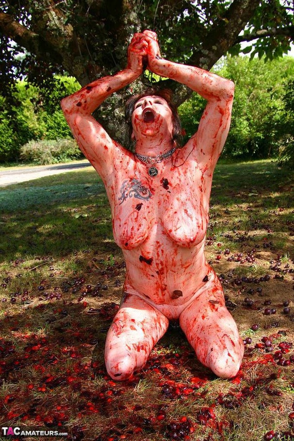 Chubby brunette with big tits gets her tattooed body covered with plums while posing on the ground outdoors - XXXonXXX - Pic 13