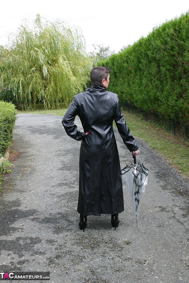 Short haired woman with red nailed and big natural posing in leather outfit before undressing and peeing outdoors - XXXonXXX - Pic 1