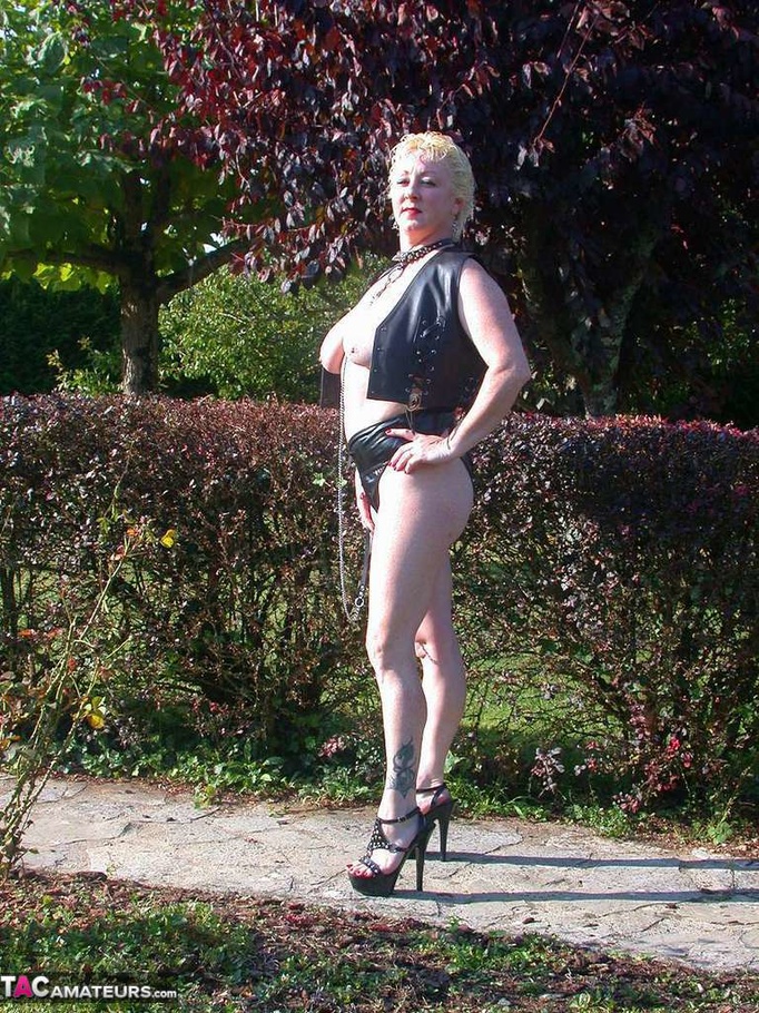 Busty blonde on a leash posing in leather outfit outdoors and slowly undressing to expose her pierced snatch - XXXonXXX - Pic 3