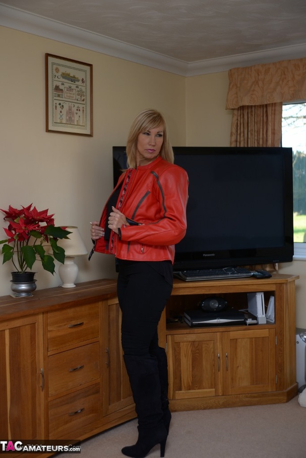 Blonde milf in black outfit and blue underwear stripteasing and exposing her pierced nipples on the floor - XXXonXXX - Pic 2