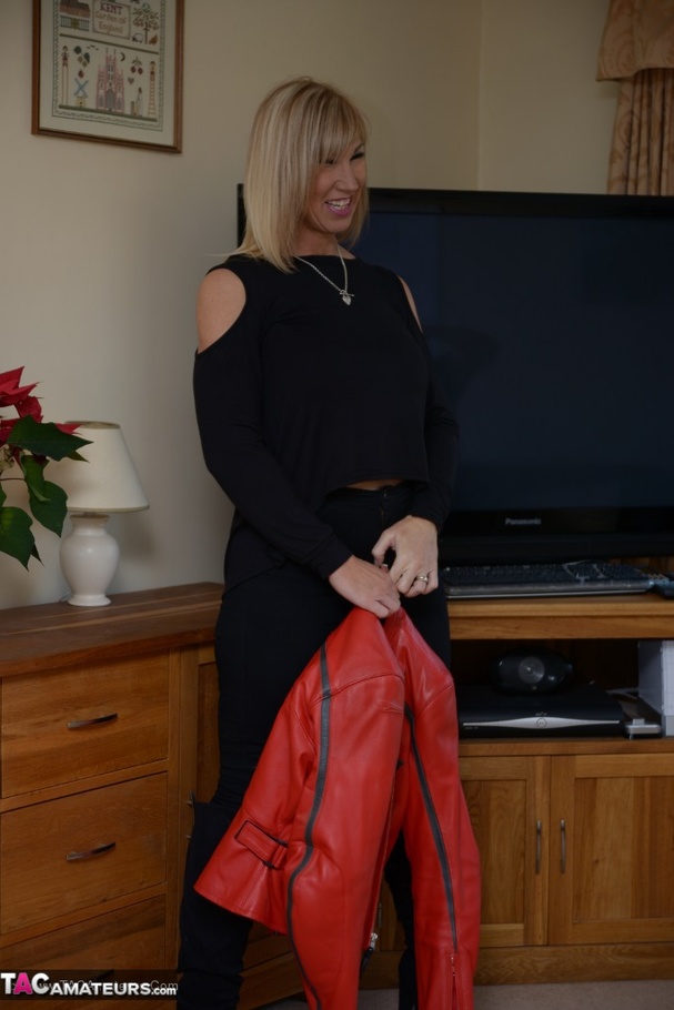Blonde milf in black outfit and blue underwear stripteasing and exposing her pierced nipples on the floor - XXXonXXX - Pic 4