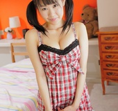 Pigtailed Japanese teen slut in checked baby-doll presents her lovely