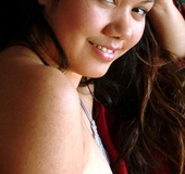 Hottie lays in lingerie and plays topless with her dark pussy