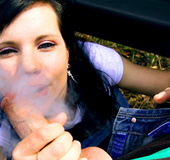 Pretty looking teen girl blowing rockhard outdoors near the car.