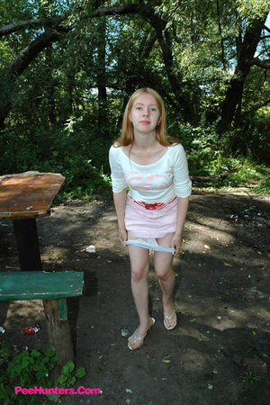 Prankish babe pisses onto a table in the park - Picture 2