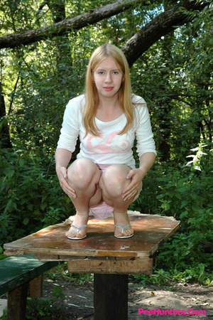 Prankish babe pisses onto a table in the park - Picture 6
