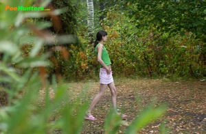 Little babe takes a leak in the nearby bushes - Picture 16