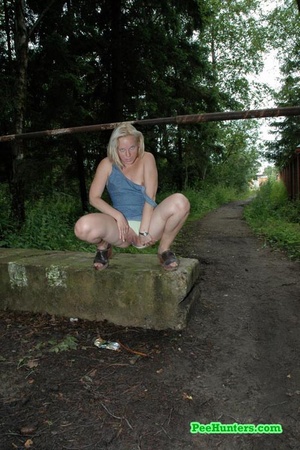 Nasty blonde teeny pissing in a quiet park - Picture 6
