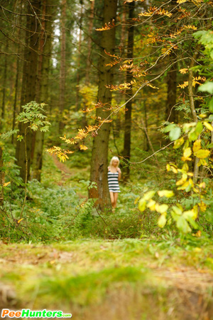 Young blonde with a lot of tattoos pisses in woods - Picture 1