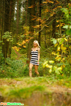 Young blonde with a lot of tattoos pisses in woods - Picture 2