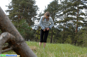 Shameless young tart caught peeing on forest path - Picture 15