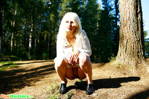 Naughty blonde pisses into a sandpit in forest - Picture 11