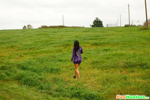 Girl pulls the hem of her dress up to pee outdoors - Picture 16