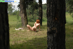 Redhead pissing in the forest under the tree - Picture 5