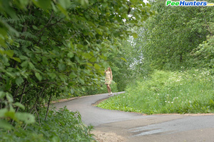 Nude cutie tinkles on the shoulder of country road - Picture 1
