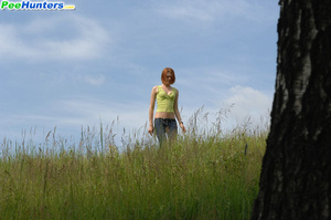 Girlie takes a leak sitting on top of a huge rock - Picture 1