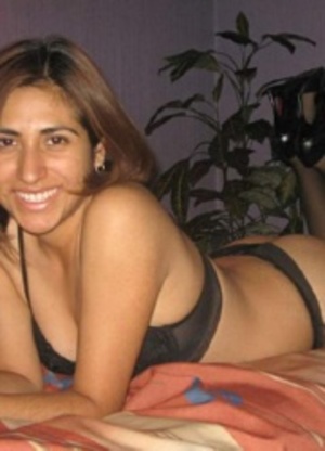 Stunning indian brunette posing on the bed in her sexy black lingerie. - Picture 2