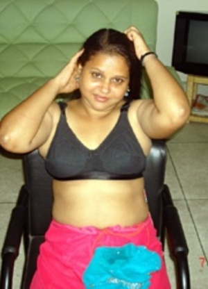 Smily busty indian plumper slowly undressing while alone at home. - Picture 1