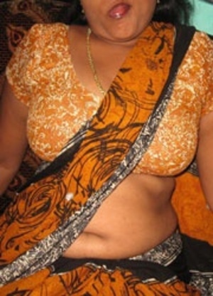 Amateur indian babe in native outfit undressing and exposing her big breast. - Picture 3